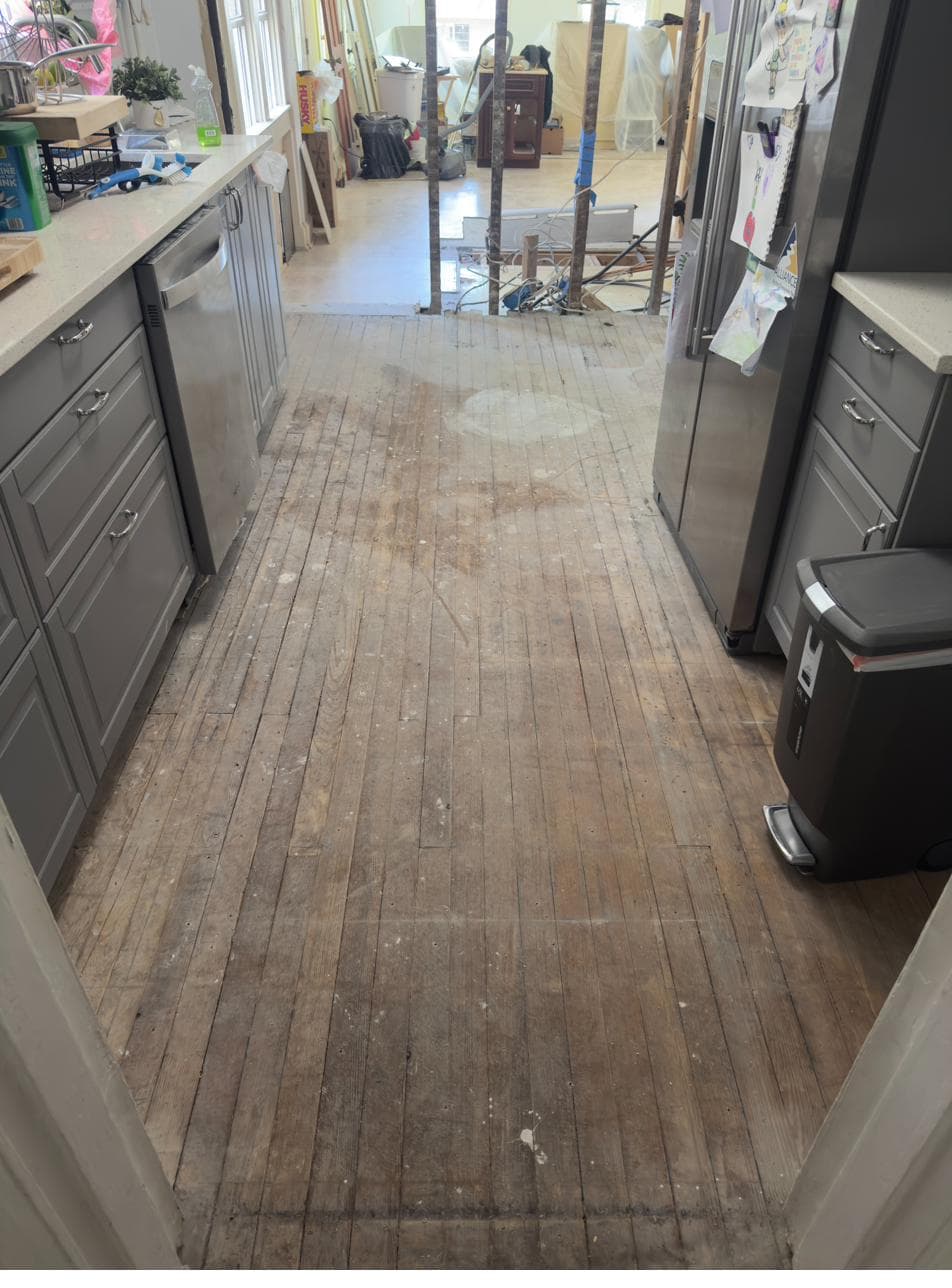 Original kitchen floor exposed after cabinet removal
