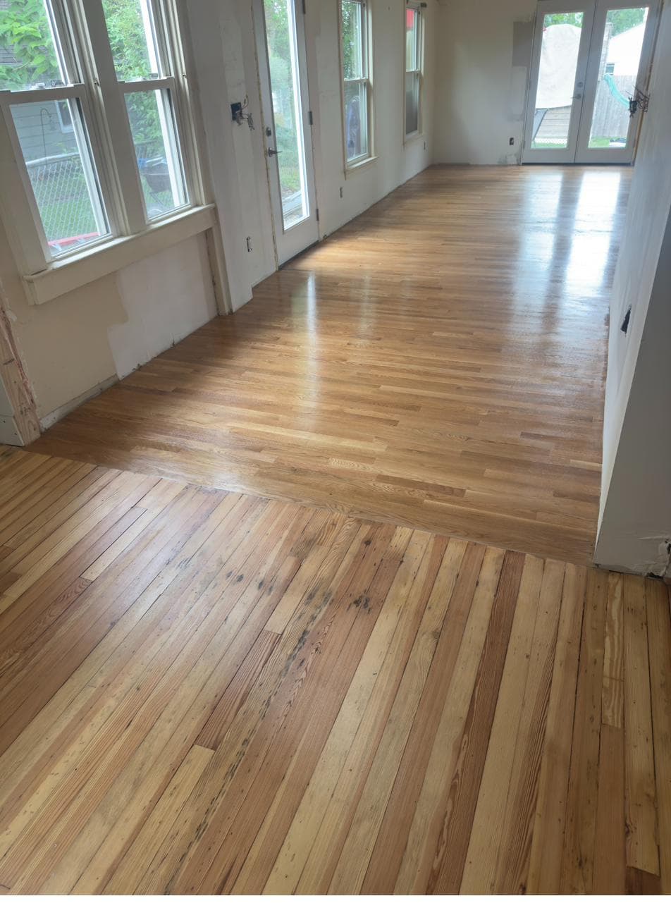 Close view of restored original pine meeting new oak
