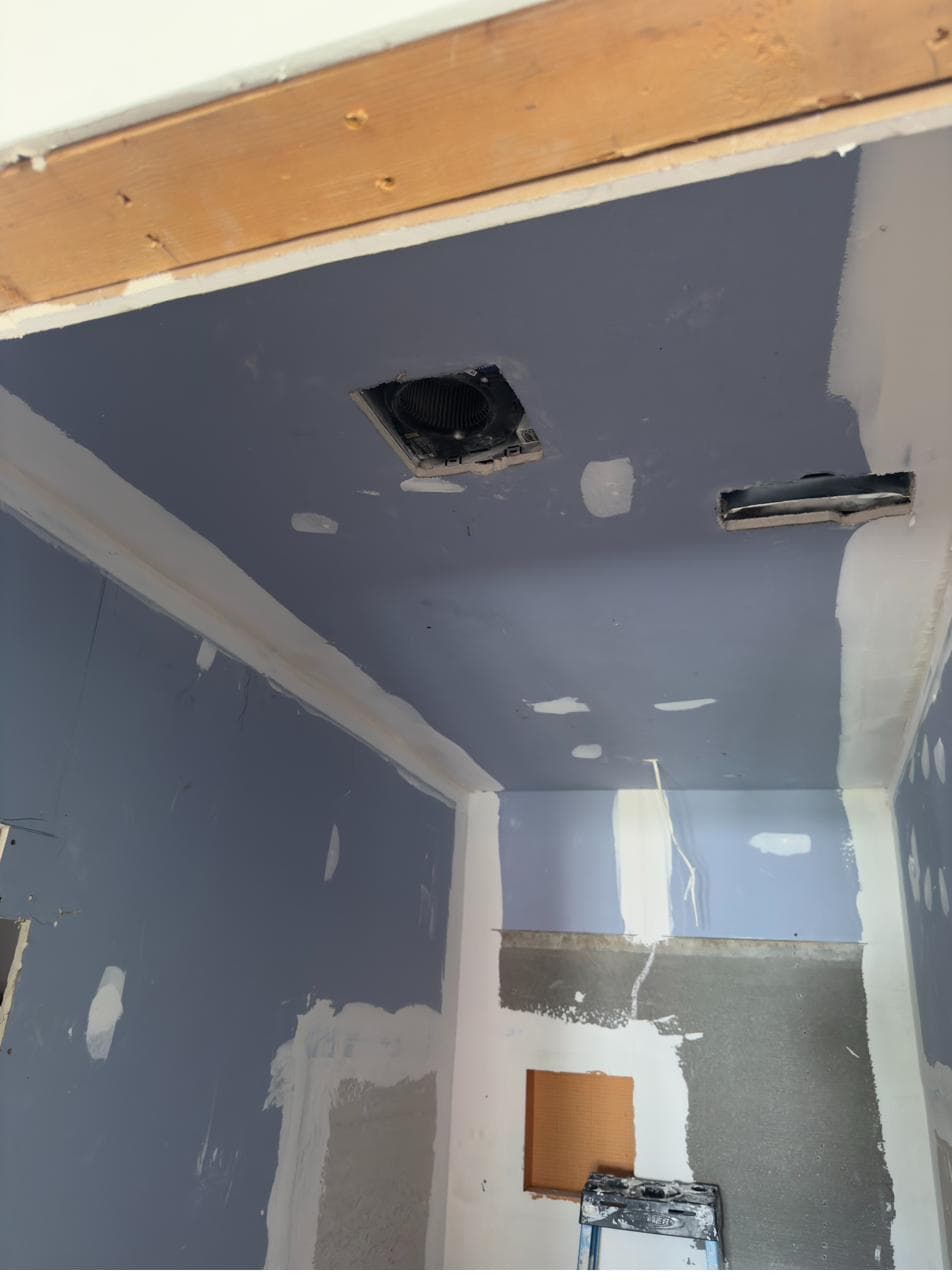 Moisture-resistant drywall and vent rough-in in the new bathroom