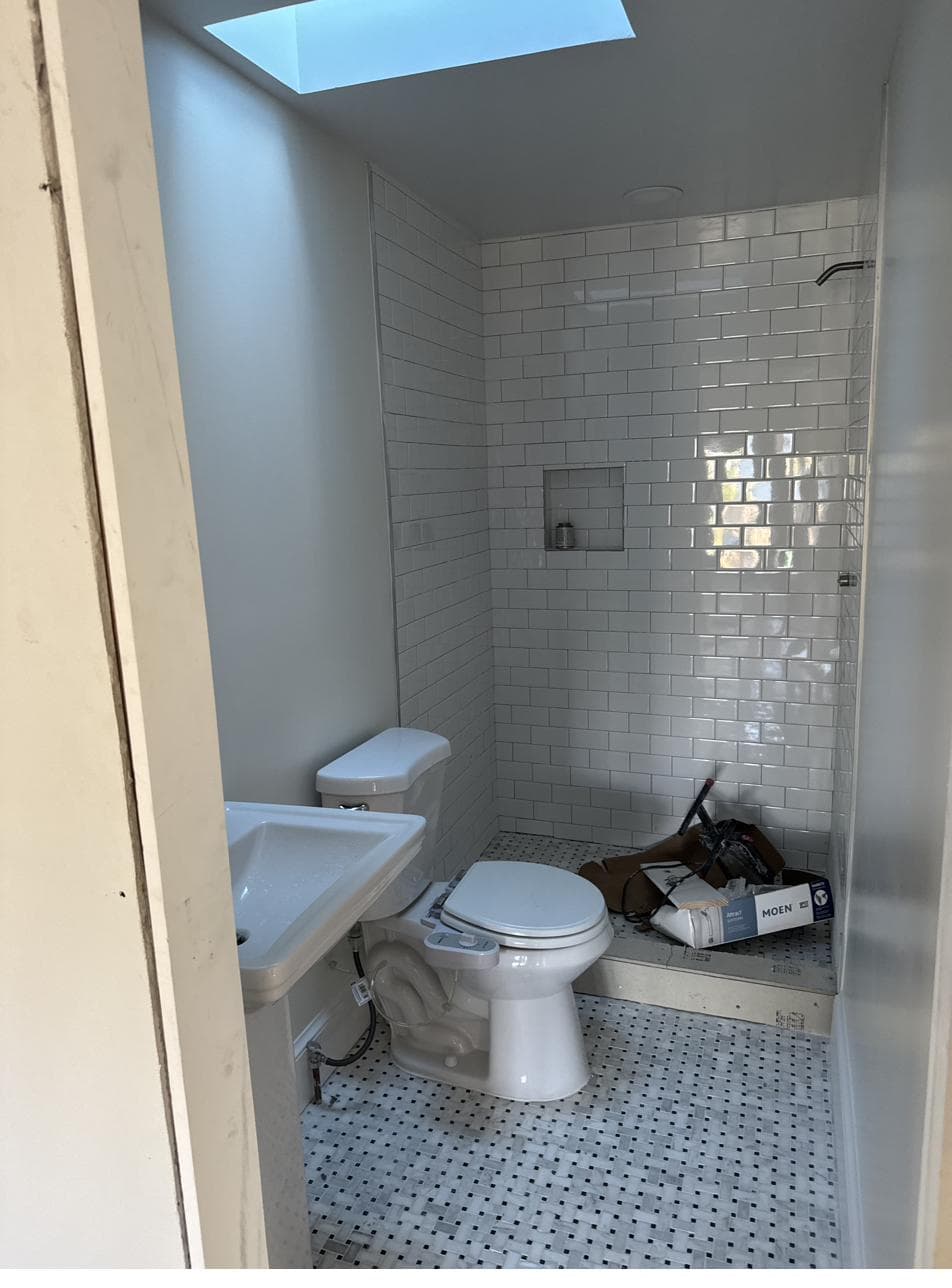 Finished bathroom: subway tile shower, marble basketweave floor, skylight